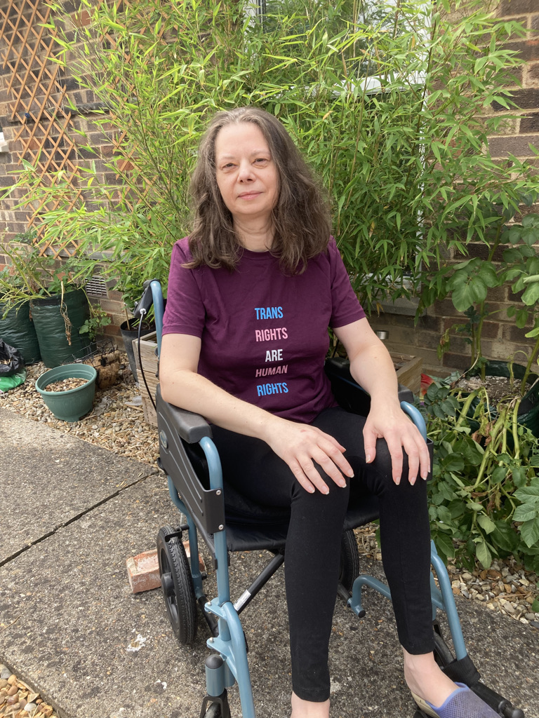 Image of Philippa Fleming sitting in her wheelchair in her back garden.