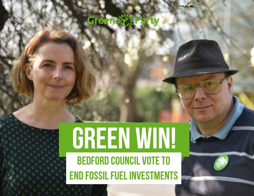 Bedford Borough Councillors Lucy & Ben With Green Party Logo and the words Green Win Bedford Council vote to end fossil fuel investments